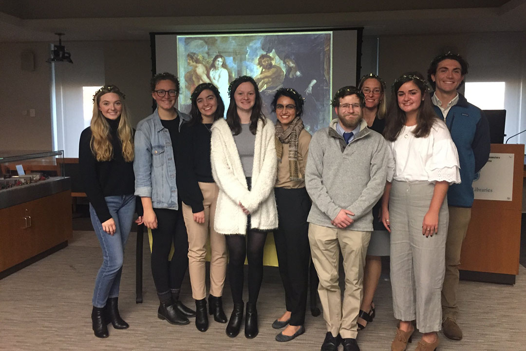 Katherine Wasden with GW students standing and wearing garland crowns