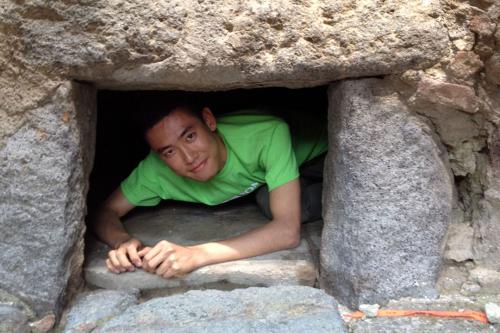 Guoshi Li, BA '16, measuring the inside of an oven in an ancient bakery at Pompeii