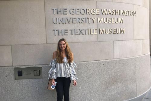 Classical Studies major Eve Svoboda standing outside the GW Textile Museum