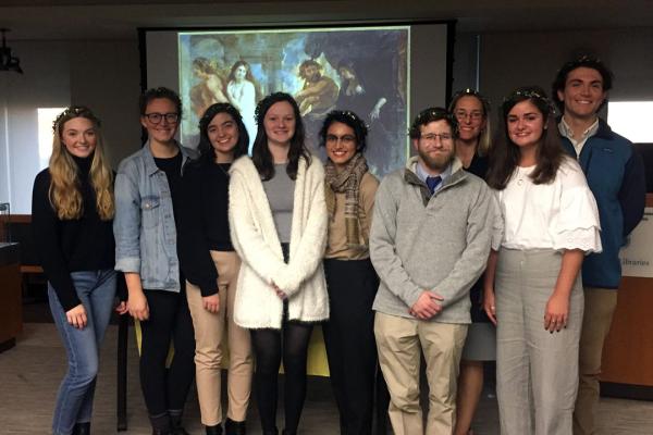 A group of CNELC students standing and wearing garlands on their heads